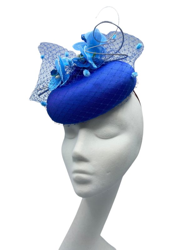 Blue headpiece with stunning lighter blue pom pom veiling and matching orchid flower detail.
